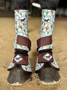 the horse's boots are decorated with images of horses and cactuses on them