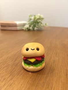 a toy hamburger sitting on top of a wooden table