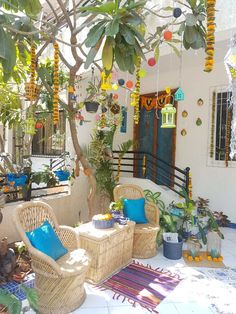 an outdoor patio with wicker furniture and plants