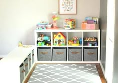 a playroom with toy bins and toys on the shelves in front of it