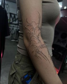 a woman with a dragon tattoo on her arm