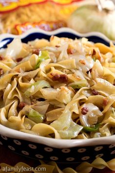 a bowl filled with pasta and vegetables on top of a table