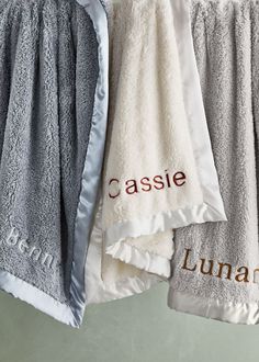 two towels hanging on a clothes line with the name casssie and luna written on them