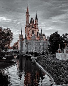 an old castle is shown in black and white with water running through the foreground