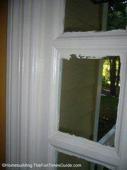 an open window in the corner of a room that has been painted white and is being repaired