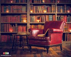 a red chair sitting in front of a book shelf filled with books