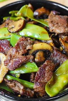 a bowl filled with meat and vegetables on top of a table