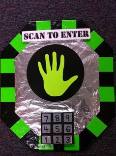 a green and black circle with a hand on it that says, scan to enter