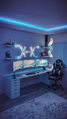 a computer desk with two monitors on it in front of a blue wall and ceiling