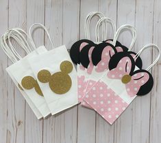 minnie mouse party bags with pink and white polka dots, gold mickey ears on them