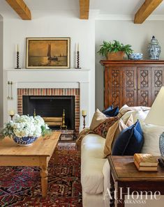 a living room filled with furniture and a fire place in front of a painting on the wall