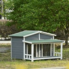 a small dog house sitting in the grass