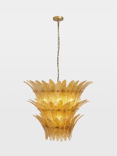 a yellow chandelier hanging from a ceiling in the shape of a pineapple