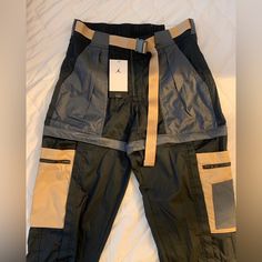 Brand New, Never Worn In Women’s Small. Black Nylon Cargo Pants With Belt Loops, Black Nylon Pants With Belt Loops, Black Nylon Cargo Pants For Work, Black Fitted Utility Parachute Pants, Fitted Black Utility Parachute Pants, Nike Urban Pants With Pockets, Nike Cargo Pants For Streetwear, Urban Nike Pants With Pockets, Nike Black Sporty Cargo Pants