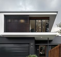 a modern house with black and white siding