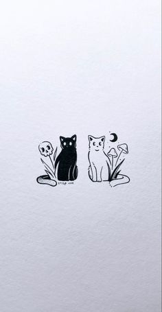 two cats sitting next to each other on top of a white sheet with black ink