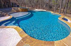 a large swimming pool surrounded by stone steps