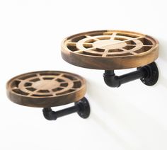 two wooden wheels are attached to the wall