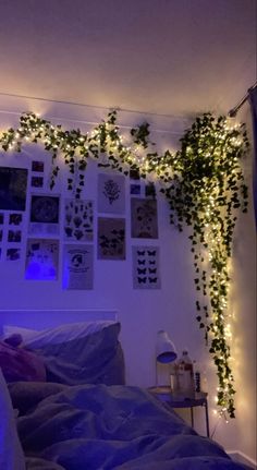 there is a bed with lights on the headboard and some plants growing over it