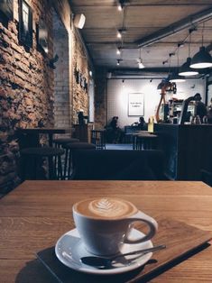 a cappuccino sitting on top of a wooden table