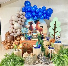 a table topped with lots of balloons and decorations