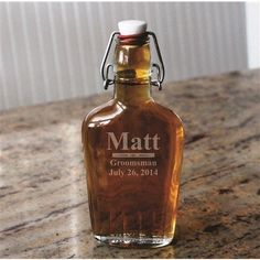 a glass bottle sitting on top of a wooden table