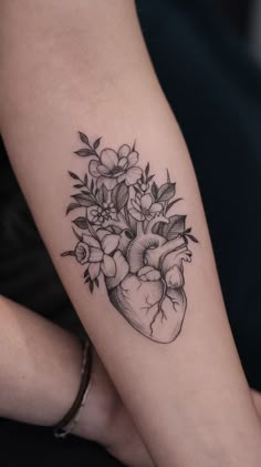 a black and white heart tattoo with flowers