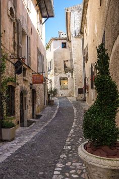 an alleyway with cobblestone streets and stone buildings