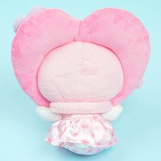 a pink heart shaped stuffed animal on a blue background