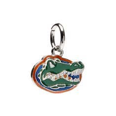 a florida gator head charm with an orange, white and blue stripe on it