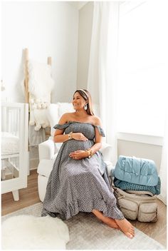 a pregnant woman sitting in a white chair