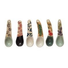 six spoons with different designs on them