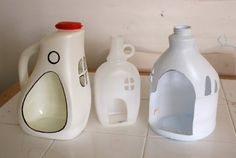 three plastic jugs sitting on top of a white tiled floor next to each other