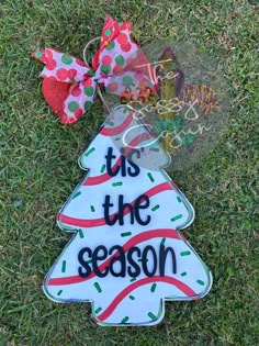 this is the season ornament with a bow on it in the grass,