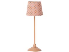 a lamp that is on top of a white surface with polka dot print fabric shade