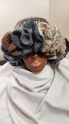 a mannequin's head wearing a knitted hat with flowers on it