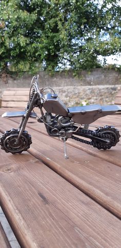 a toy motorcycle sitting on top of a wooden table