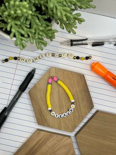 a wooden board with some beads and pens on it