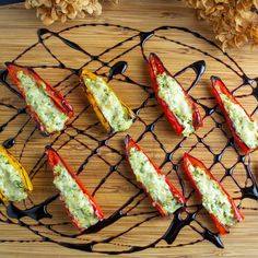 six stuffed peppers on a wire rack with melted cheese and seasoning sprinkles