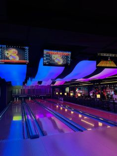 the bowling alley is lit up with neon lights