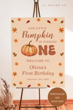 a sign that says our little pumpkin is turning one welcome to olsino's first birthday