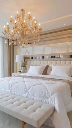 a bedroom with a chandelier and white bedding