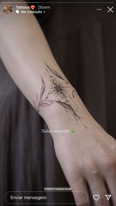 a person's arm with a flower tattoo on it