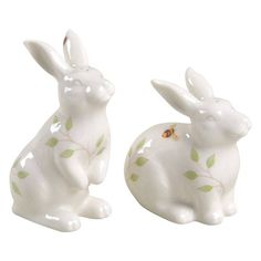 two white ceramic rabbits sitting next to each other