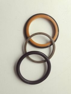 three different types of rings hanging on the wall