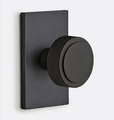 the black knob is attached to the wall