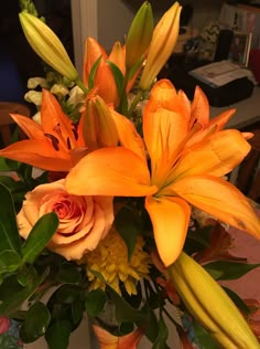 a vase filled with orange flowers on top of a table