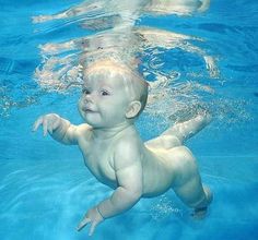 a baby is swimming in the water