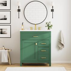 a bathroom with a green cabinet and white rug in front of the sink, framed pictures on the wall