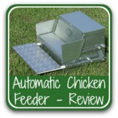 the automatic chicken feeder is sitting in the grass